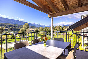 Spacious balcony/terrace with sun loungers and view of the lake and mountains
